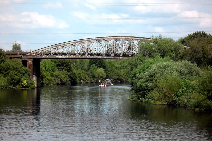 A narrow boat passes under the derelict railway viaduct, Garforth